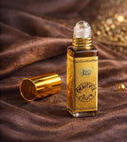 Gold 'Beautiful Touch' concentrated perfume bottle and packaging on a dark background